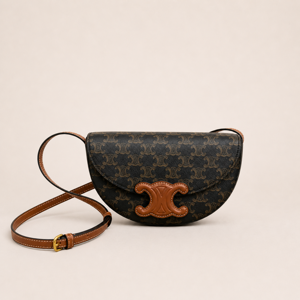 Mini Crescent Crossbody Bag in Monogram Canvas & Smooth Calfskin Leather – Structured Saddle Silhouette with Gold Accent Clasp